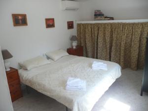 ein Schlafzimmer mit einem Bett mit zwei Handtüchern darauf in der Unterkunft Finca de la Fuente in Coín