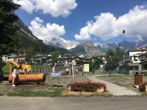 a park with a playground with mountains in the background at La Maisonnette in Pré-Saint-Didier