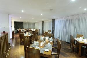 a dining room with wooden tables and chairs at Serenus Boutique Villa in Nuwara Eliya