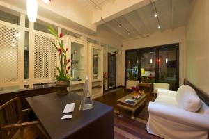 a living room with a white couch and a table at Sabye Bangkok in Bangkok