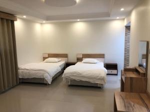 Ένα ή περισσότερα κρεβάτια σε δωμάτιο στο رؤية عنيزة - Vision of Onaizah