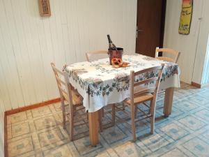 a dining room table with a bottle of wine on it at Aux 6 hirondelles in Ammerschwihr