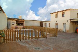 a wooden fence in front of a house at La Quinteria de Sancho in Argamasilla de Alba