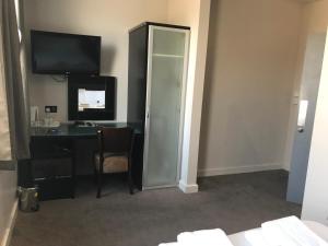 a hotel room with a desk and a mirror at Hatfield Lodge in Lowestoft