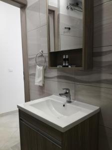 a bathroom with a white sink and a mirror at Icthyoessa in Agios Kirykos +87 photos