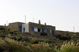 a house on top of a hill at Bioclimatic stone built villa in Kastrianí