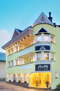 a large yellow building with a sign on it at Alpinstyle Hotel Ischgl in Ischgl