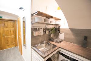 a kitchen with a sink and a counter top at The Maze Apartment in Ljubljana