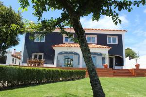 una casa con una pared azul y un patio en HappySintra GuestHouse by Casa do Preto, en Sintra