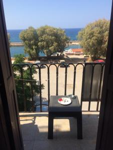 a table on a balcony with a view of the ocean at Rooms 47 in Chania