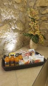 a tray of orange juice and a vase of flowers at Castello San Felice in Verona