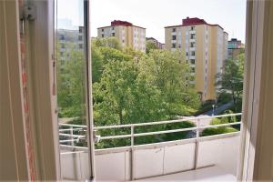 an open window with a view of a city at Spacious flat with balcony in central & hip area in Gothenburg