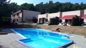 a large blue swimming pool in front of a building at Wisełka Studio in Wisełka