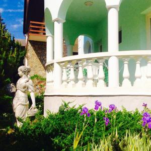 a statue of a woman in front of a house at Villa Valeria in Hévíz