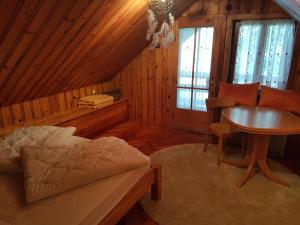a bedroom with a bed and a table in a room at Chalet am See in Keutschach am See