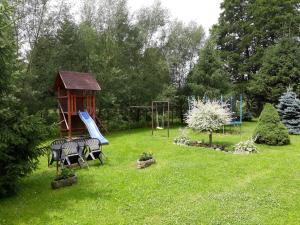 a yard with a playground with tables and a play structure at Pension u Adršpachu - Dana Tyšerová in Janovice