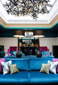 a blue couch with pillows in a living room at Tiffany Hotel in Geneva