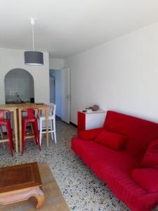 a living room with a red couch and a table at Hendaye location in Hendaye