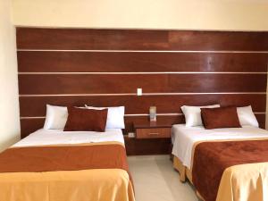 een hotelkamer met 2 bedden in een kamer bij Hotel Mirto in Puebla