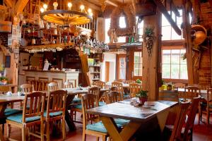 a restaurant with tables and chairs in a room at Spreewaldpension Andreas Krüger in Schlepzig