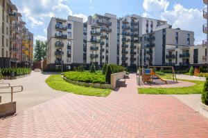 a brick walkway in front of buildings with a playground at #stayhere - Comfy & Stylish Studio with Green Patio close to Old Town in Vilnius