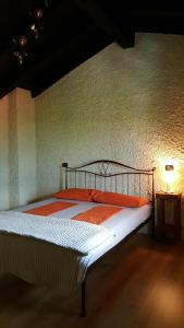 1 dormitorio con 1 cama en una habitación con pared en Casa Ronit, en Delebio