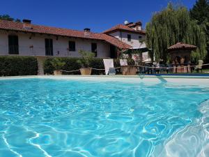 a pool of water in front of a house at La Cascina Del Castello in Asti