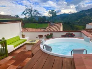 a hot tub on the deck of a house at El Despertar Hotel in Jericó
