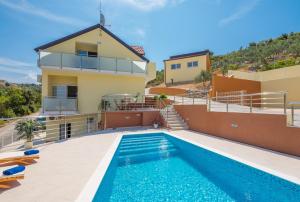 una villa con piscina y una casa en Villa Olive Tree, en Rogoznica