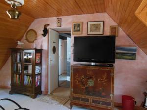 a living room with a flat screen tv on a wall at Ty An Eol in Saint-Évarzec