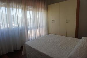 Postel nebo postele na pokoji v ubytování Residence La Piazzetta