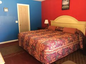 a bedroom with a bed and a dresser at Ole Miss Motel in Oxford