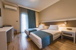 Postel nebo postele na pokoji v ubytování Elia Hotel Cunda by Ortunc