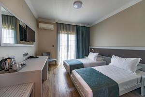 Postel nebo postele na pokoji v ubytování Elia Hotel Cunda by Ortunc