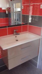 a bathroom with a white sink and a mirror at La Hall in Thiers +12 photos