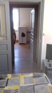 a room with a hallway with a door and a room with a door at La Hall in Thiers