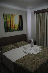 Ένα ή περισσότερα κρεβάτια σε δωμάτιο στο Veredas do Rio Quente Flat