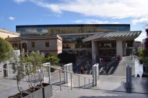 a building with people walking in front of it at Absolute Athens IV in Athens