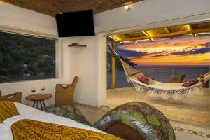 a bedroom with a hammock in a room with a view at Villa Lala Boutique Hotel Adults Only in Puerto Vallarta
