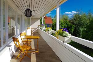a porch with chairs and a table and flowers at GuestHouse Arctic Heart in Rovaniemi