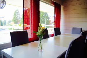 a vase of flowers sitting on a table in a room at GuestHouse Arctic Heart in Rovaniemi