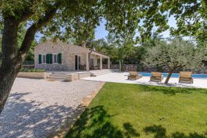 a backyard with a house and a pool at Casa Egi in Rovinj