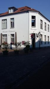 a large white building on the side of a street at Weindepot Xanten in Xanten
