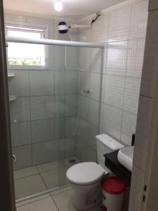 a bathroom with a shower with a toilet and a sink at Vista Lateral Mar Massaguaçu in Caraguatatuba