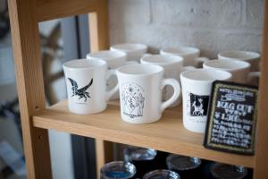 a group of coffee cups sitting on a shelf at Hotel Pacific Kanazawa in Kanazawa