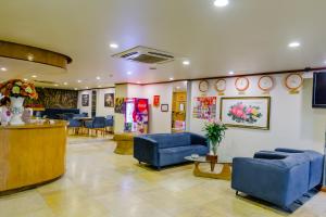 a waiting room with blue chairs and a counter at A25 Hotel - 12 Ngô Sỹ Liên in Hanoi