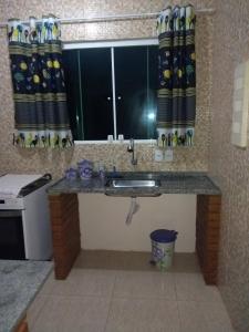 ein Bad mit einem Waschbecken und einem Fenster in einem Zimmer in der Unterkunft Cantinho do Aconchego in Paraty + 17 Fotos