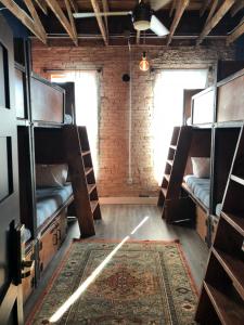 a room with bunk beds and a rug at Deep Ellum Hostel in Dallas
