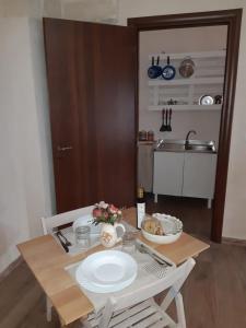 a table with a white plate on it in a kitchen at Le 5 Volte in Avetrana +28 photos