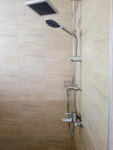 een douche met een douchekop in de badkamer bij Apartment Terrace under the stars in Primorsko
